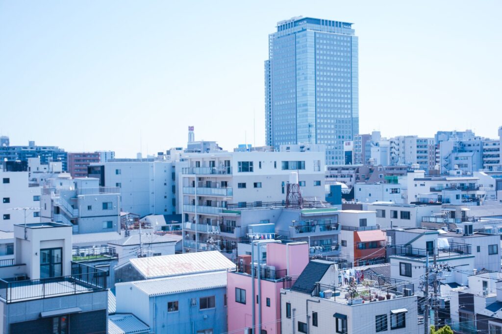 Overlooking a vibrant Tokyo neighborhood, blending residential and urban landscapes under a clear sky.