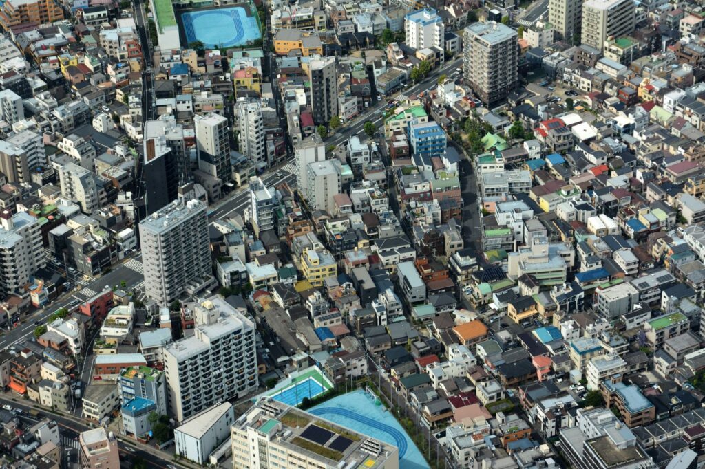 Aerial view highlighting Tokyo's dense urban residential area with mixed housing types.