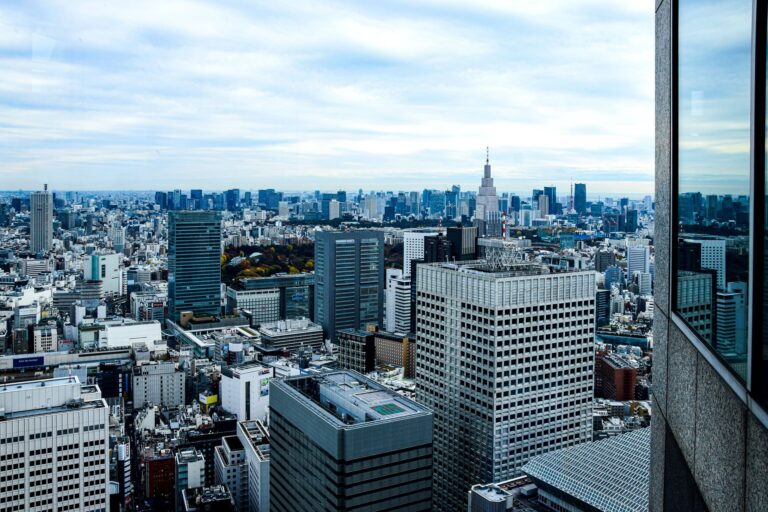Aerial view of Tokyo's modern skyline featuring dense skyscrapers and iconic architecture.