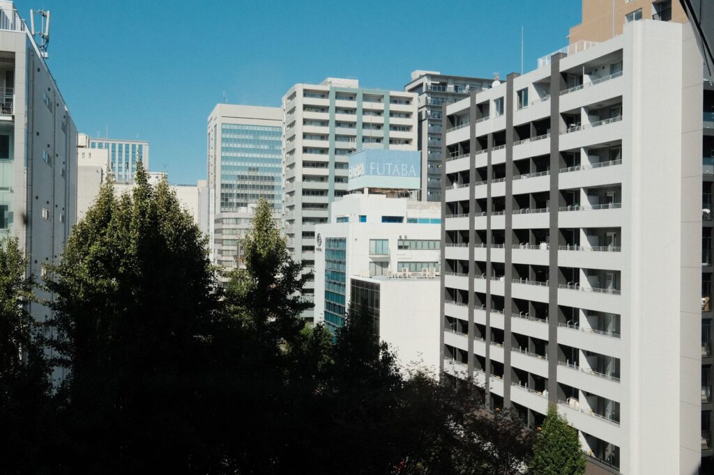 High-rise buildings against a blue sky in Nagoya, Aichi, Japan's urban landscape.
