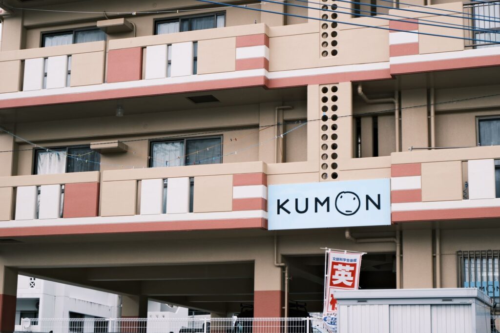 Residential building in Tokyo, Japan, featuring Kumon sign and urban architecture.
