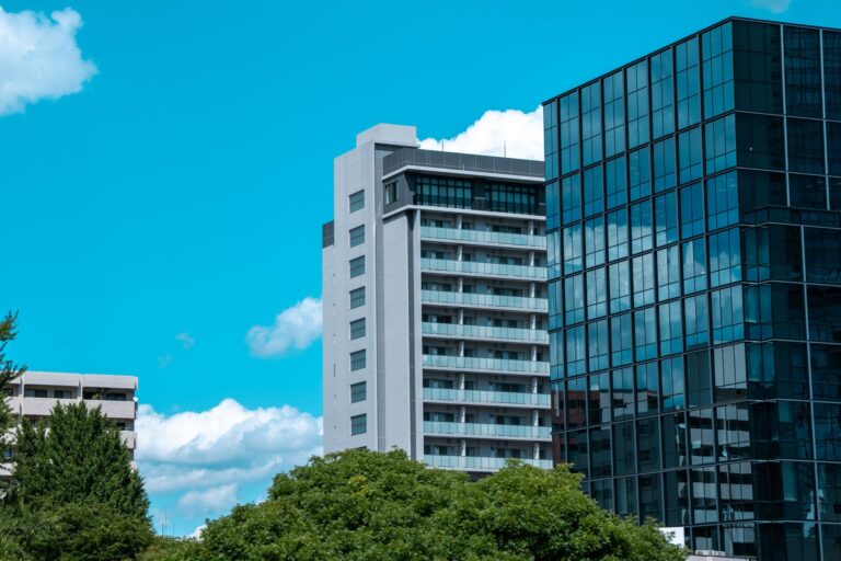 Modern buildings in Tokyo against a bright blue sky, showcasing contemporary urban architecture.