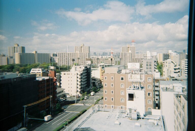 Skyline view of modern city architecture under a bright blue sky, ideal for travel and urban themes.