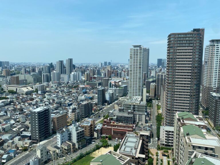 High-angle shot of Tokyo's urban skyline with skyscrapers and residential buildings.