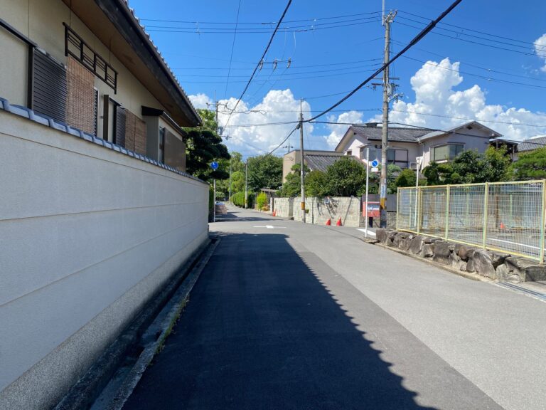 Tranquil suburban street in Osaka with clear blue skies and Japanese architecture.