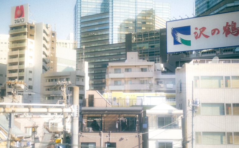 A nostalgic view of Japanese urban architecture under a pastel sky.
