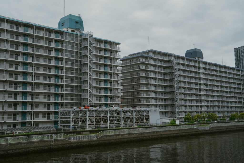 View of modern apartment buildings near a canal in Tokyo, Japan showcasing urban architecture.