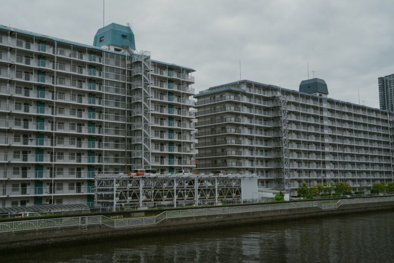 View of modern apartment buildings near a canal in Tokyo, Japan showcasing urban architecture.