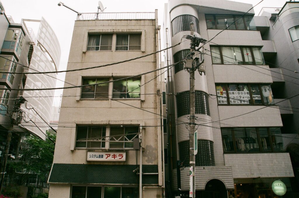 Street view showcasing a blend of old and modern buildings in Tokyo, Japan.