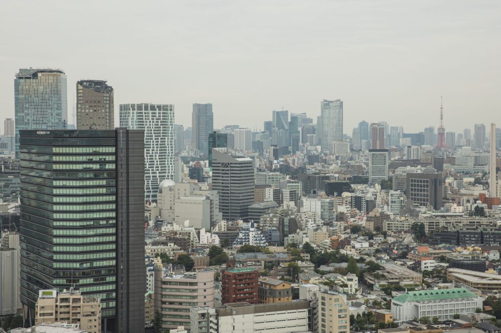 Aerial view of modern city with glass skyscrapers and multistory buildings in overcast weather
