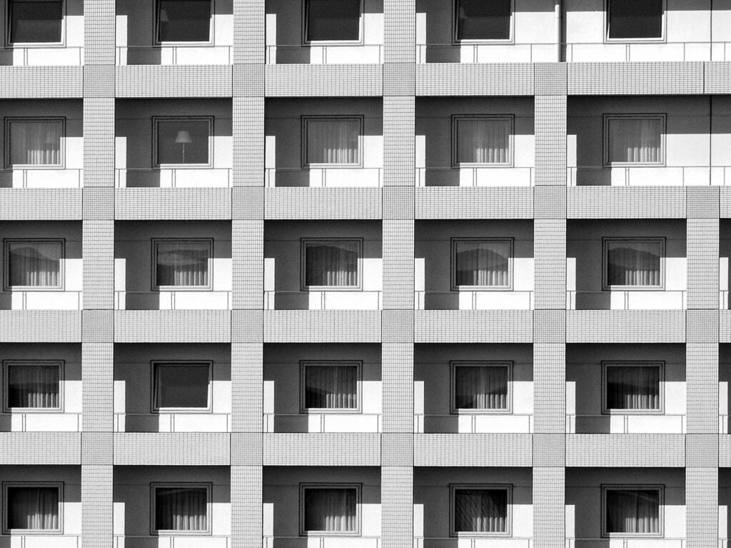 Black and white of contemporary facade of hotel complex in downtown of city