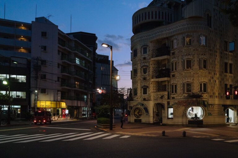 Twilight cityscape of Chuo City in Tokyo with unique architecture and bustling street scene.