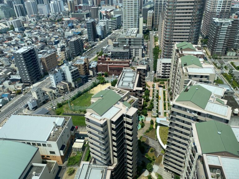 Aerial view of urban landscape with high-rise residential buildings on a sunny day.
