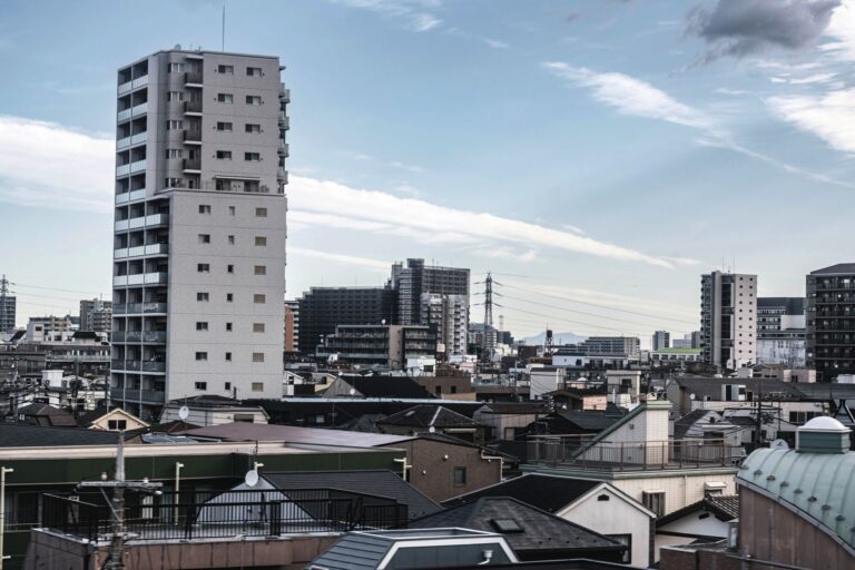 View of Tokyo's urban skyline with high-rise buildings under a clear sky.